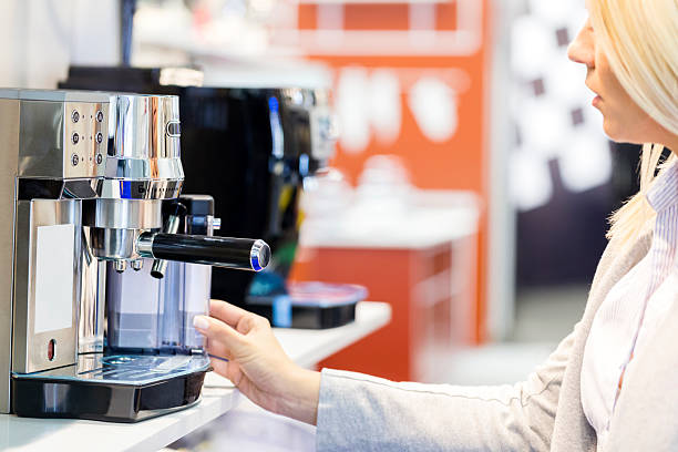 Woman shopping for esppresso maker in electronics store